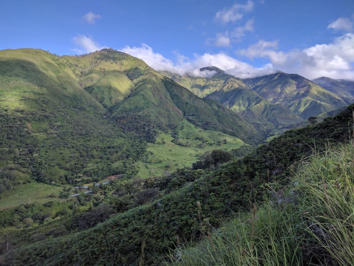 Photo of a valley surrounded by green hills in Costa Rica