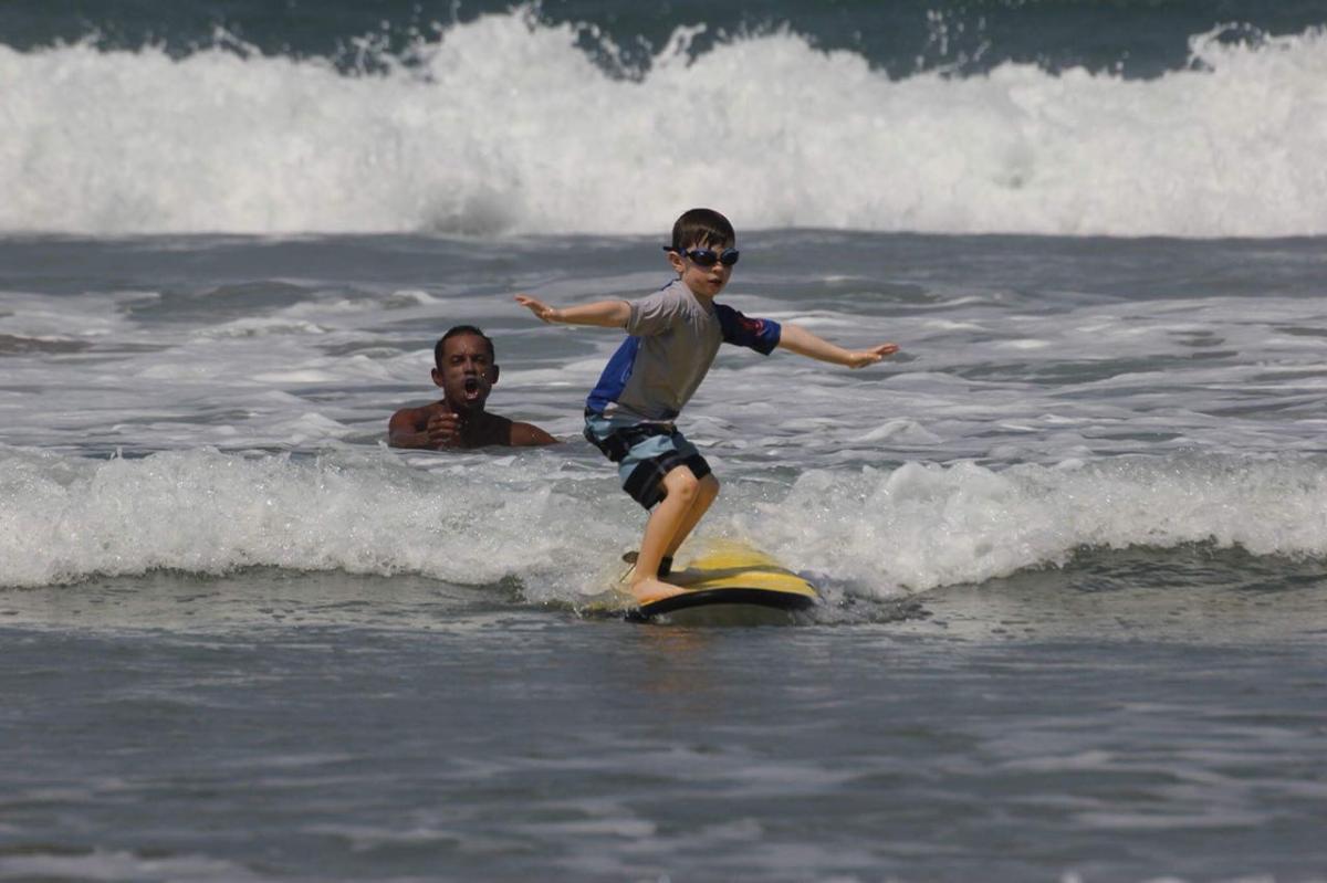 Young boy learning to surf in Tamarindo Costa Rica